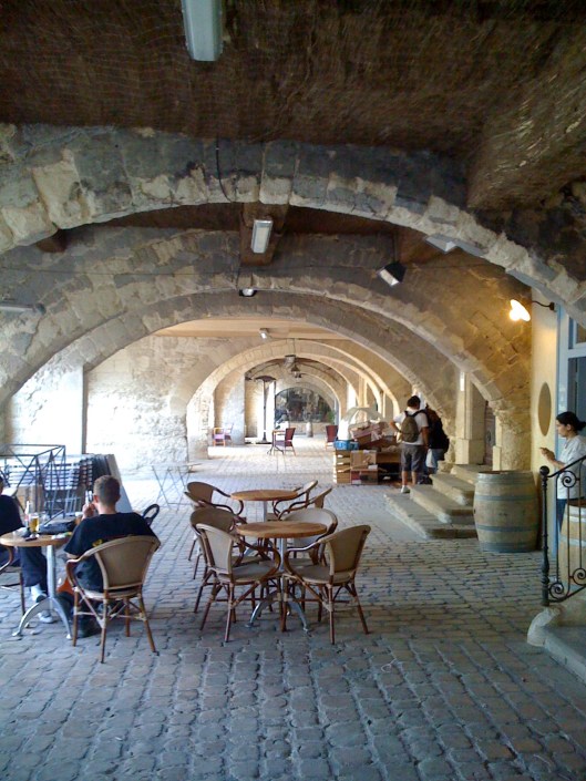 We have room for a couple of tables and a few barstools inside, at the very most, so our customers sit under the arches or out in the town square